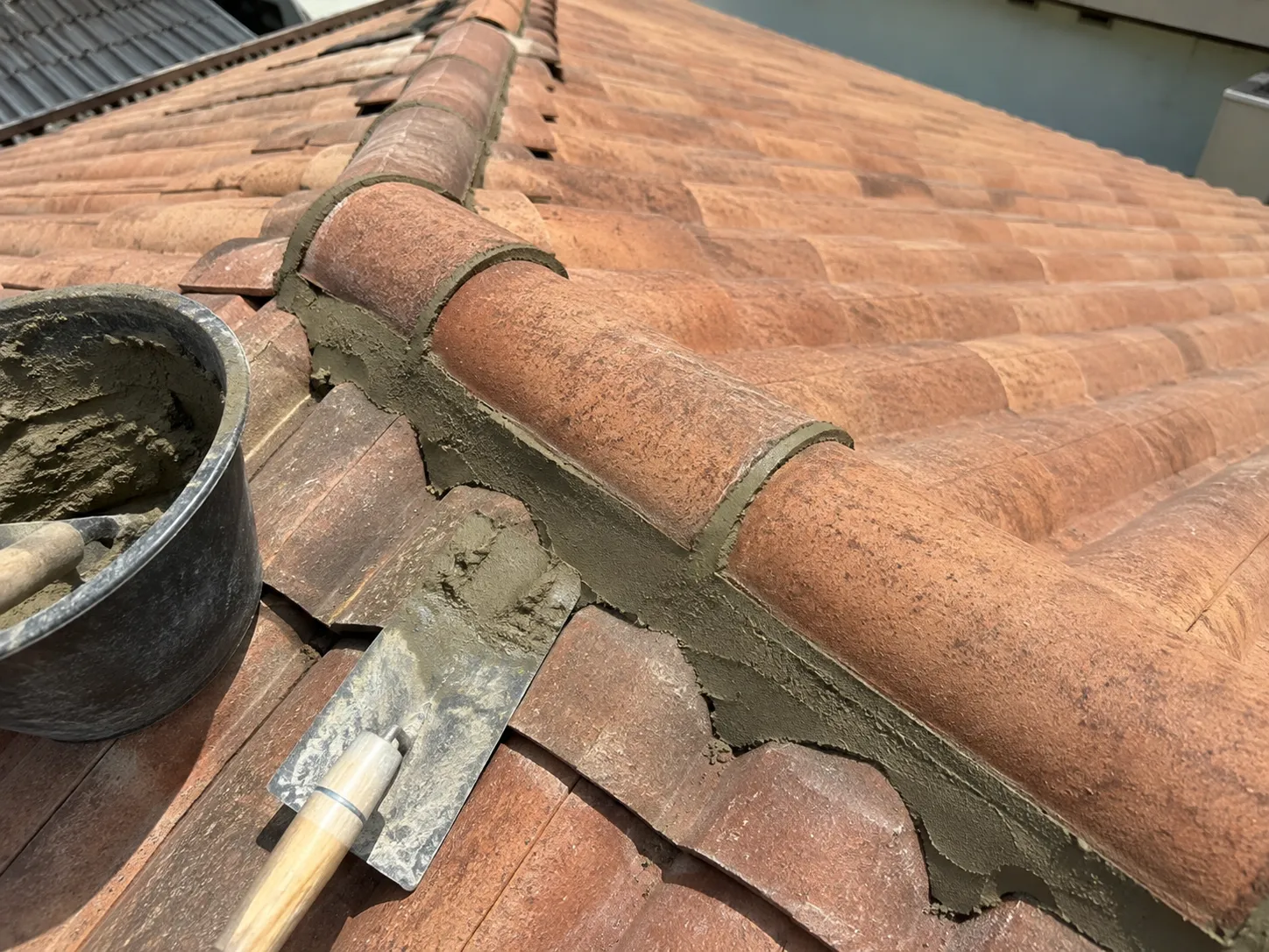 Close-up of clay tile ridge cap and course detail