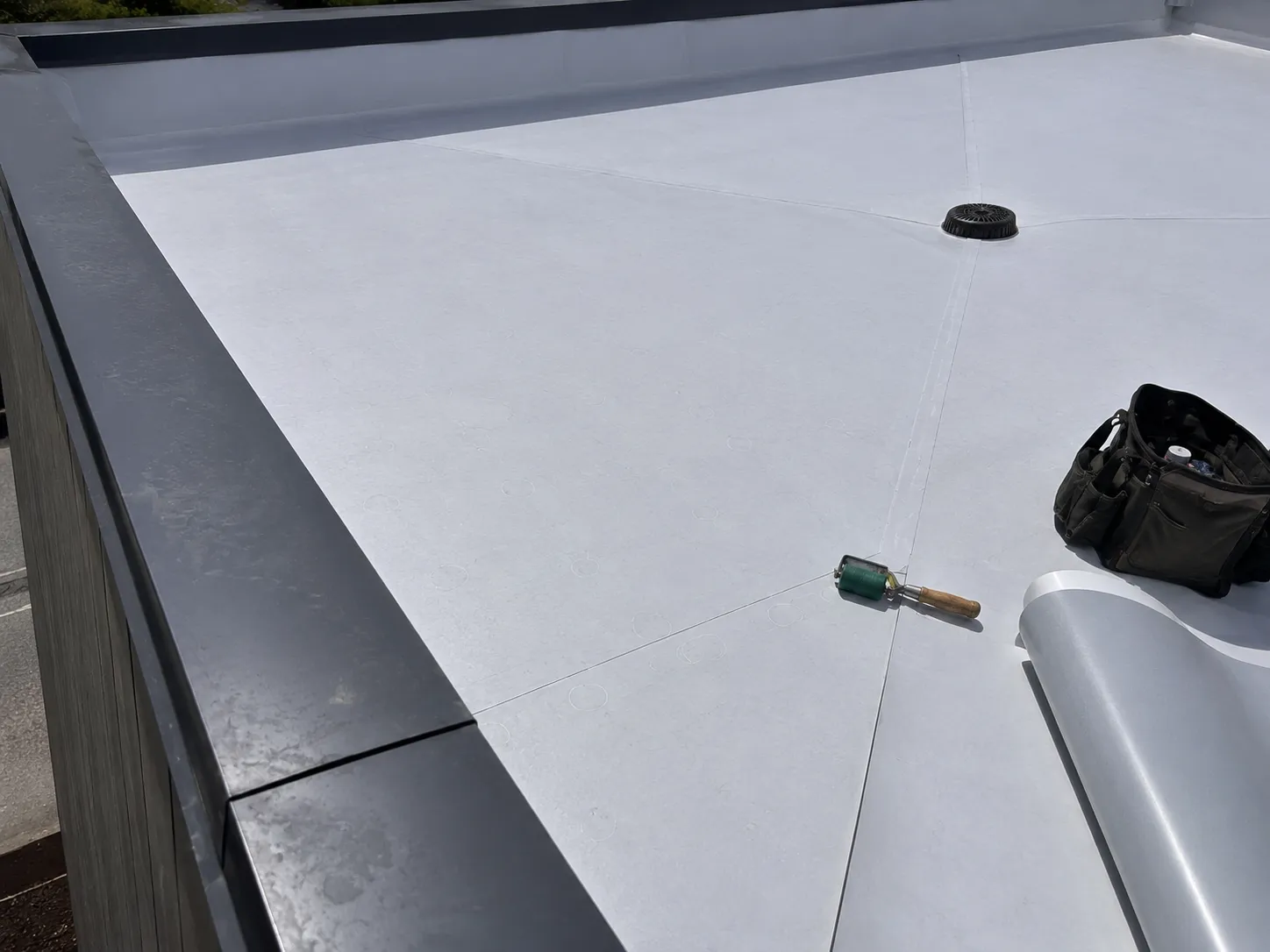 New TPO flat roof installation with roof drain detail — Surrey, BC
